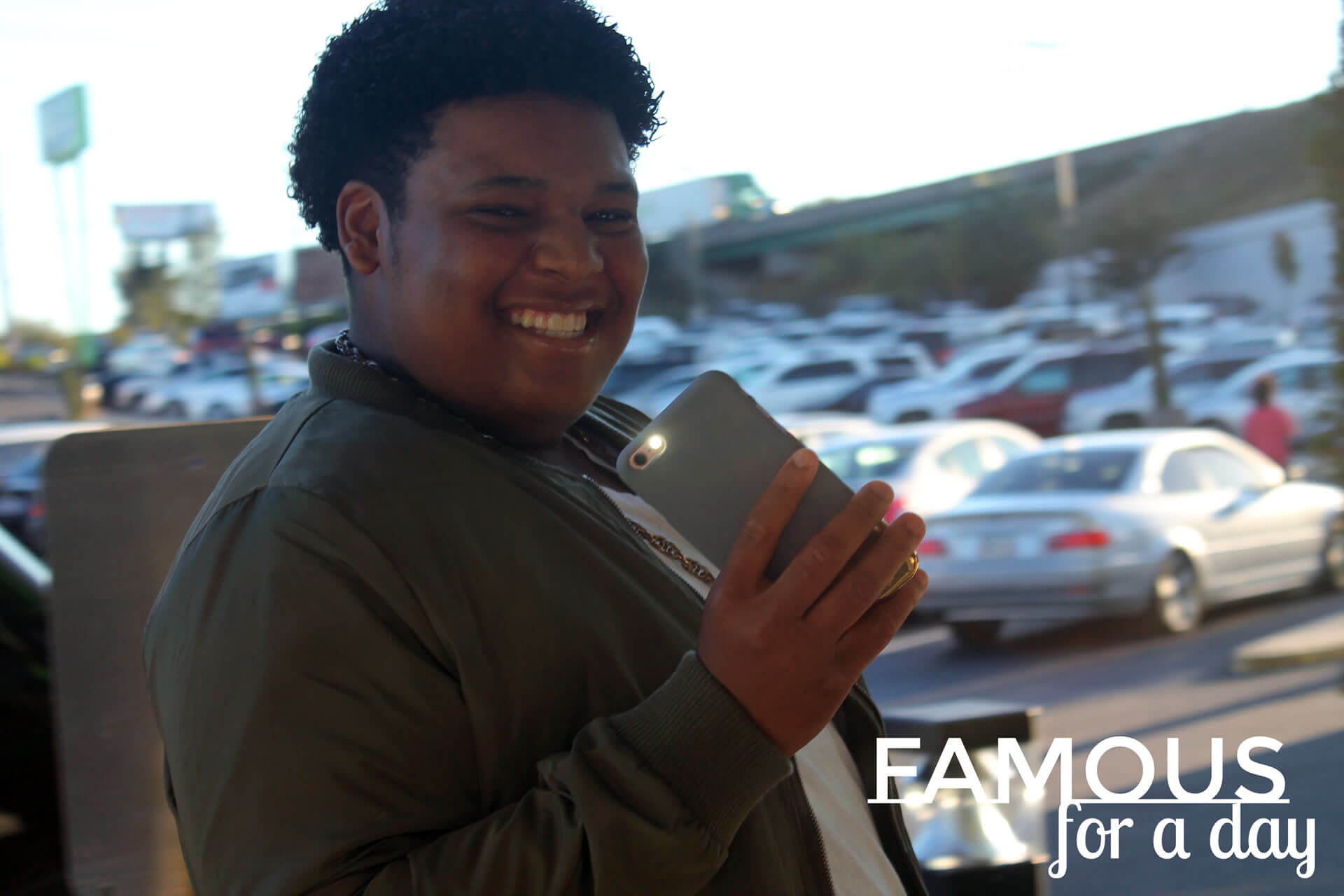 Woman dressed in formal attire smiling while posing for photos on a red carpet